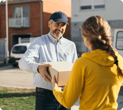 Last mile delivery (LMD) person handing package delivery recipient. Last mile delivery (LMD) person handing package delivery recipient.